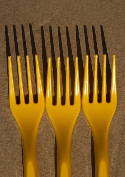 Bright Yellow Plastic Forks Cardboard Casts Shadow — Stock Photo, Image