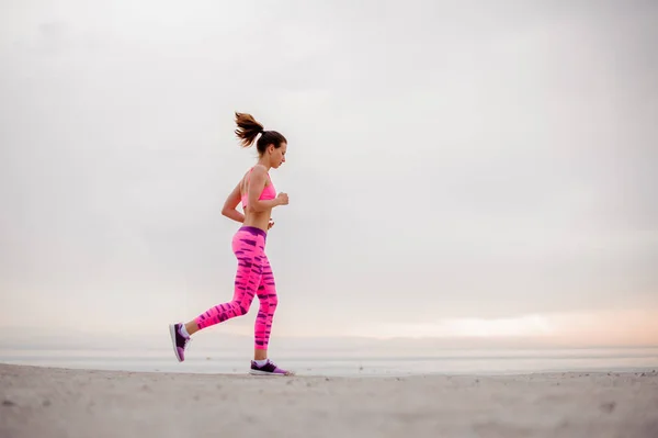 Slank Jonge Vrouw Gekleed Roze Sportswear Lopen Het Strand Tijdens — Stockfoto