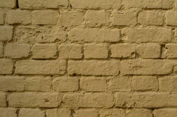 Brique jaune fond texturé rustique avec un ciment dans une couture — Photo