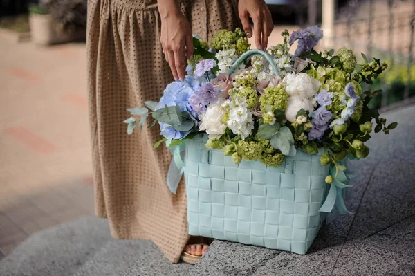 Young Girl Beige Dress Standing Huge Blue Basket Tender White — Stock Photo, Image