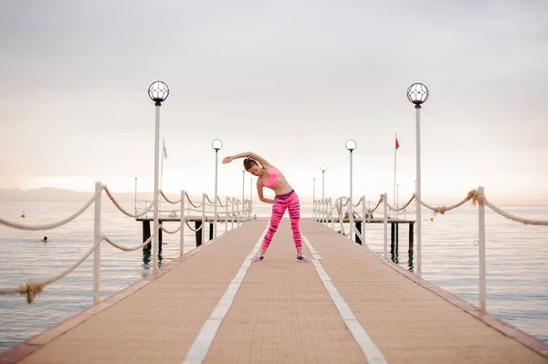 Young Sport Girl Exercises Sunrise Sea Bridge Conception Healthy Lifestyle — Stock Photo, Image