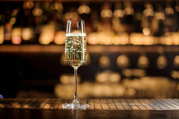 Glass of champagne standing on the bar counter — Stock Photo, Image