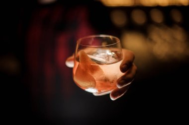 Barmen el viski dof bardak taze Kaptan James Cook kokteyl ışık arka planda tutarak
