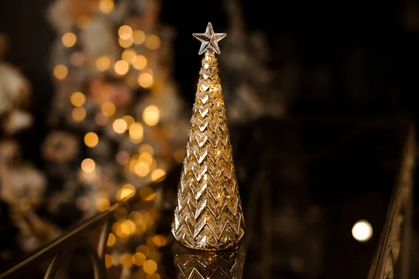 花輪に対してテーブルの上に飾られたクリスマス ツリーの形のエレガントなクリスマスもみ木グッズ — ストック写真