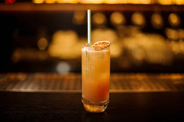 Singapore Cocktail con fetta di lime essiccata sul bancone del bar in legno — Foto Stock