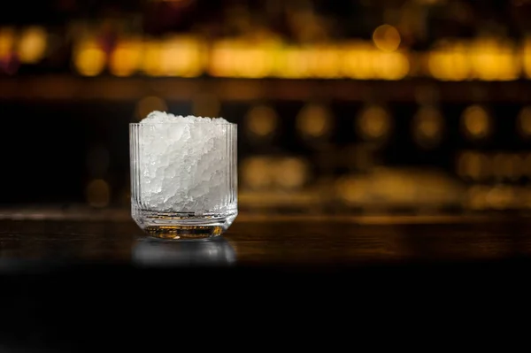 Glass with ice cubes on the bar counter of restaurant