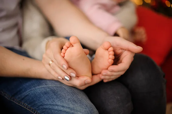 Woman holding her cute little daughter trotters on hands — Stock Photo, Image
