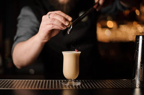 Professional bartender adding to a delicious cocktail grated nutmeg — Stock Photo, Image