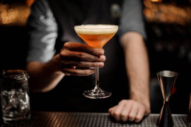 Bir krem ve rendelenmiş hindistan cevizi ile kokteyl servis erkek barmen