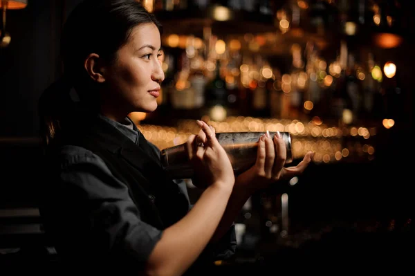 Brunette bartender girl holding a steel shaker — Stock Photo, Image