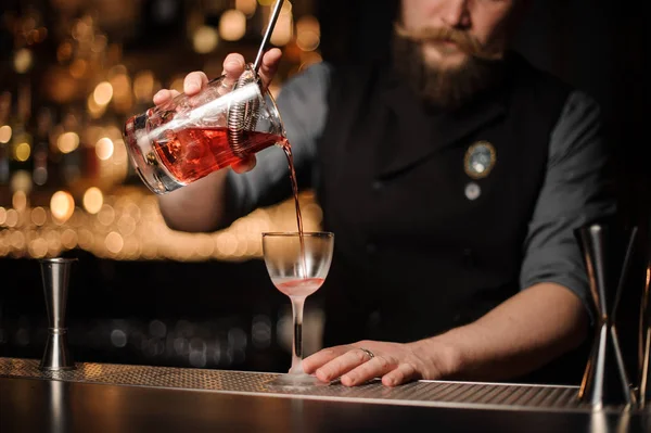 Barkeeper schenkt Alkohol-Cocktail mit Sieb ein — Stockfoto