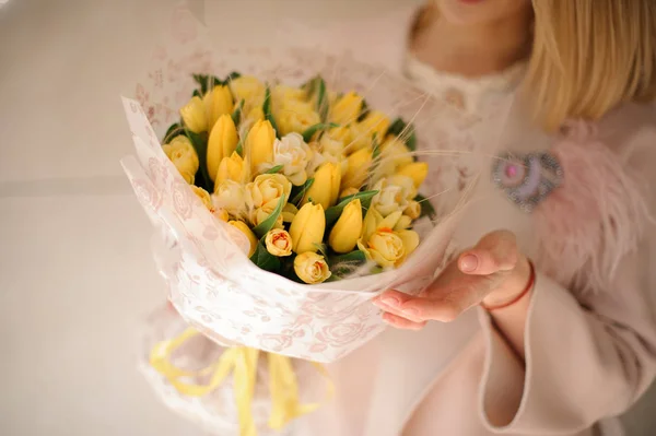 Bunch of yellow tulips in girls hands — Stock Photo, Image