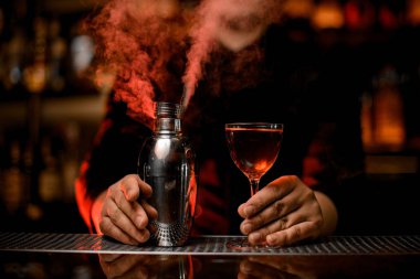 Profesyonel barmen cam ve dumanlı shaker bir kokteyl tutan