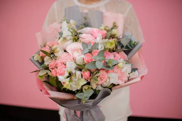 Bukiet różnych kwiatów w szarym i różowym papierze — Zdjęcie stockowe
