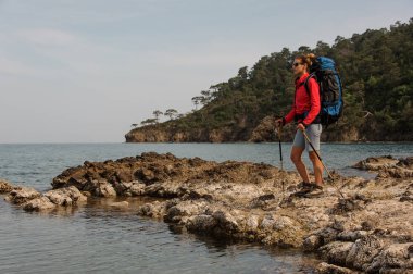 Deniz kıyısında yürüyüş sırt çantası ile kadın