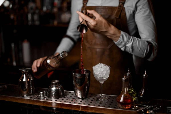 Barman derramando bebida de jigger para shaker — Fotografia de Stock