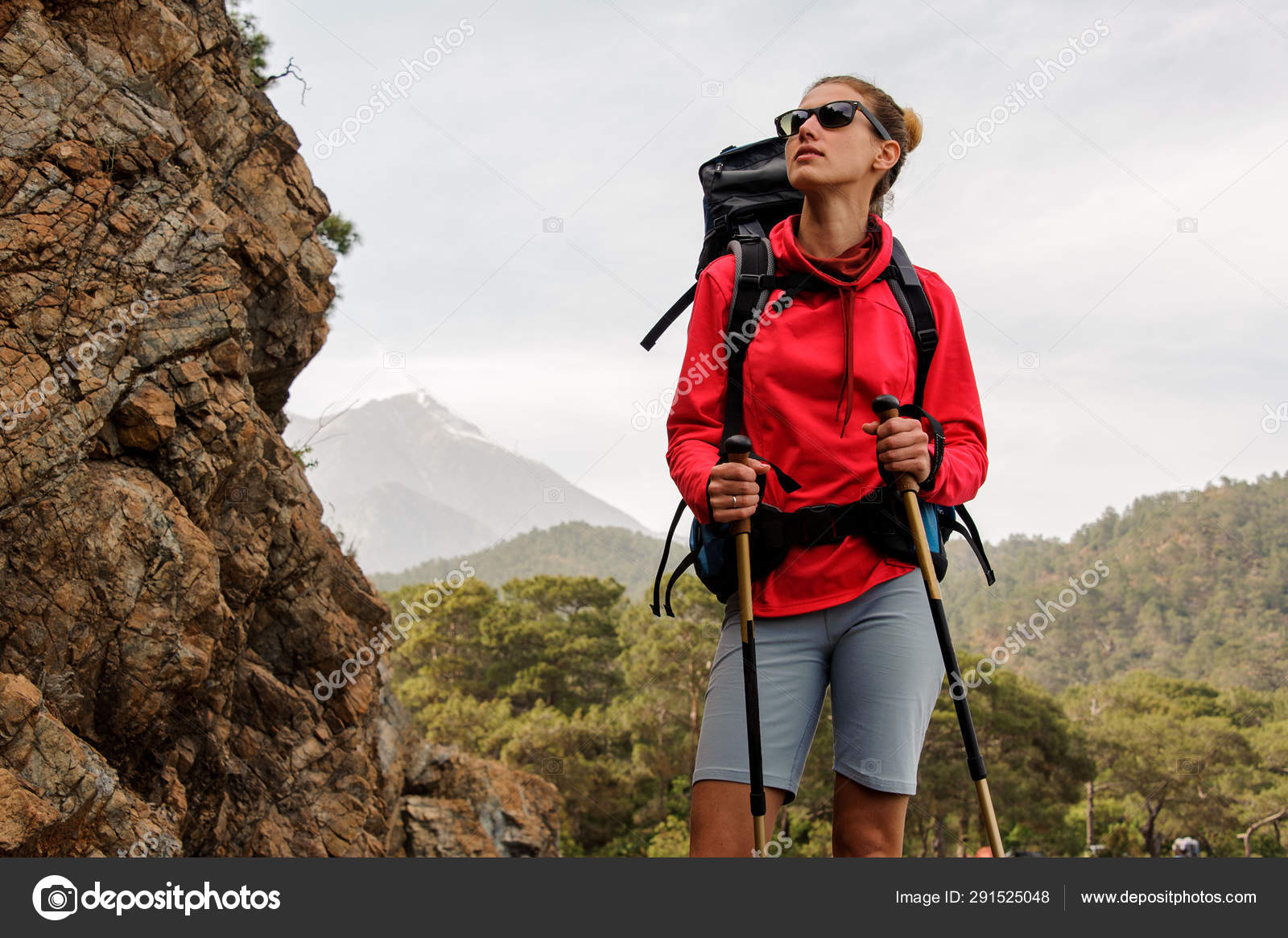 Positive Woman Casual Clothes Stands Rock Mountains Hike Poses Camera Stock  Photo by ©bodnarphoto 595134852