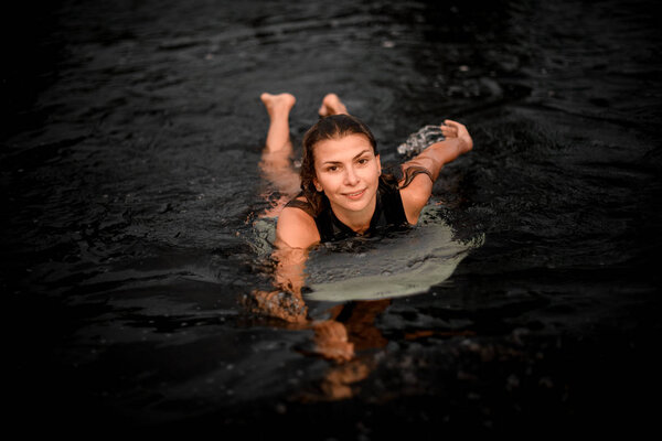 Portrait of a beautiful wakesurfer swimming in river