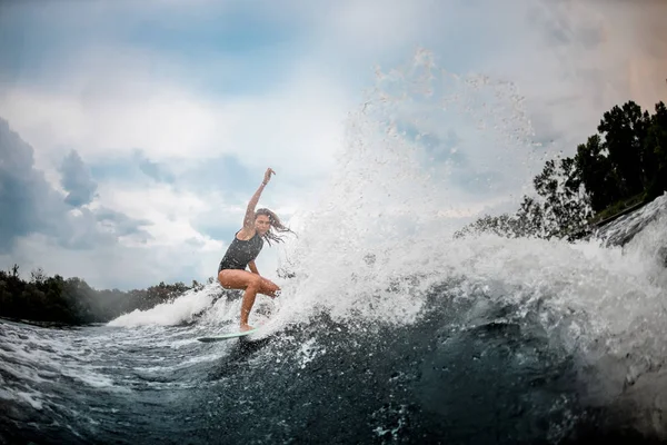 Girl wakesurfer glijdt soepel op een plank — Stockfoto