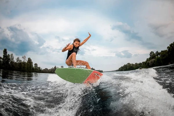 Girl wakesurfer jumping with the surf board — ストック写真