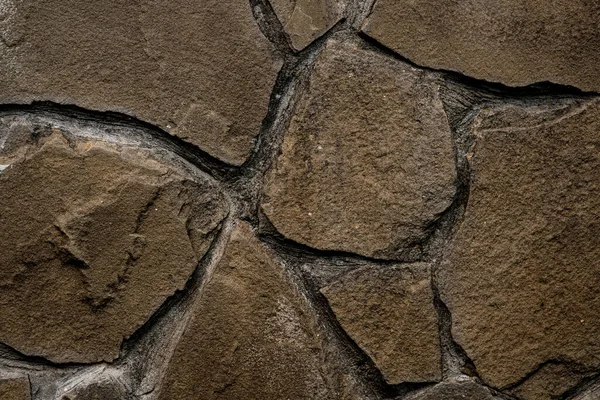 Textura abstrata de pedra marrom de forma indefinida colocada na parede — Fotografia de Stock