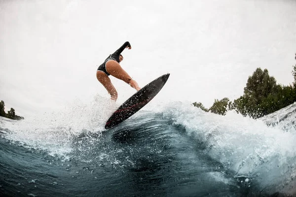 Spectacular view of ass of woman jumping on a wave — 스톡 사진