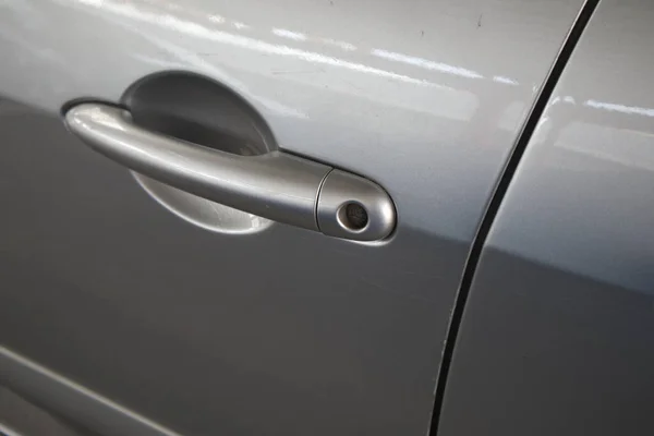 Lock detail of the driver\'s door lock of a modern car in silver gray color