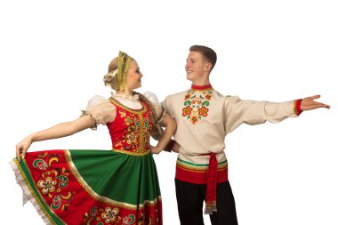 Beautiful caucasian cuple dancing in Russian folk costumes isolated on white background