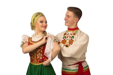 Beautiful caucasian cuple dancing in Russian folk costumes isolated on white background