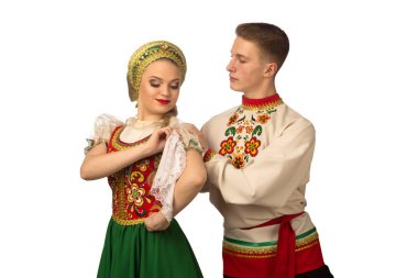 Beautiful caucasian cuple dancing in Russian folk costumes isolated on white background