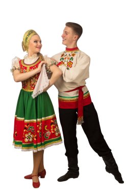 Beautiful caucasian cuple dancing in Russian folk costumes isolated on white background