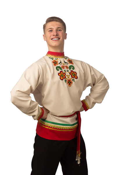 Attractive russian guy dancing in folk costume isolated on white background