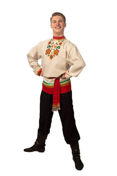 Attractive russian guy dancing in folk costume isolated on white background