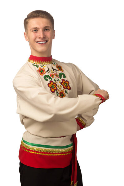 Attractive russian guy dancing in folk costume isolated on white background