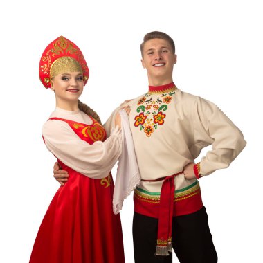 Beautiful caucasian cuple dancing in Russian folk costumes isolated on white background
