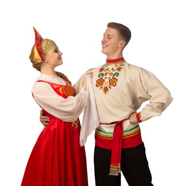 Beautiful caucasian cuple dancing in Russian folk costumes isolated on white background