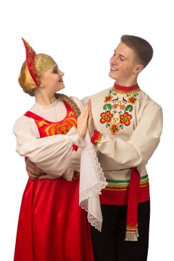 Beautiful caucasian cuple dancing in Russian folk costumes isolated on white background