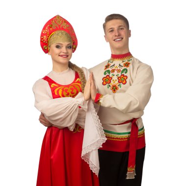 Beautiful caucasian cuple dancing in Russian folk costumes isolated on white background