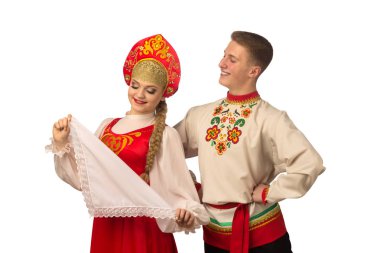 Beautiful caucasian cuple dancing in Russian folk costumes isolated on white background