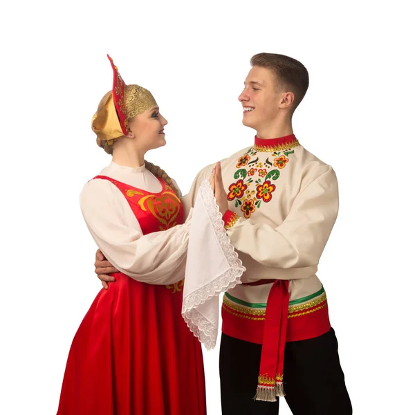Beautiful caucasian cuple dancing in Russian folk costumes isolated on white background