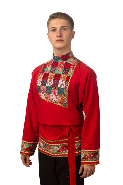 Portrait of the attractive russian guy in red folk costume isolated on white background