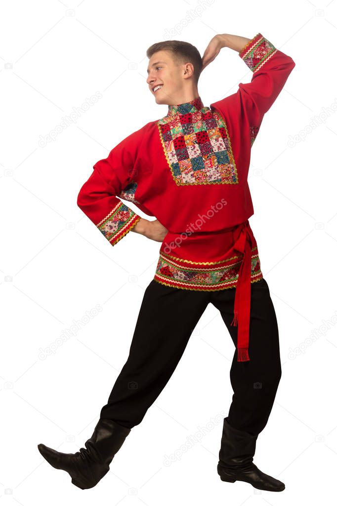 Attractive russian guy dancing in folk costume isolated on white background