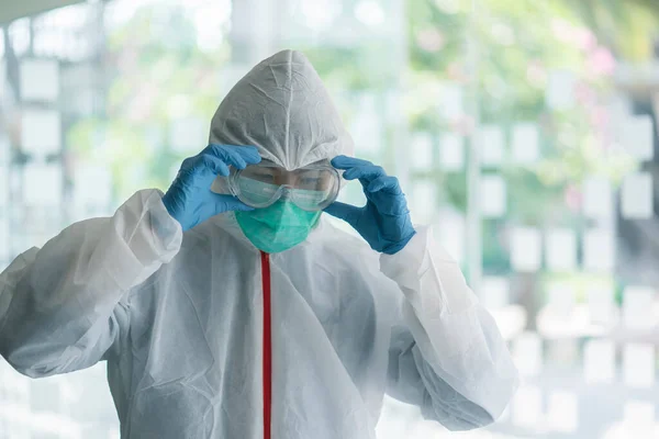 Medical Doctor wears protective suit, mask and glasses before working for protection Corona virus or Covid-19.