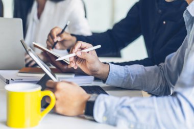 Business team discussing together in conference room during meeting at office. Teamwork, brainstorm and ideas concept. saleperson using tablet and presentation somthing to client.