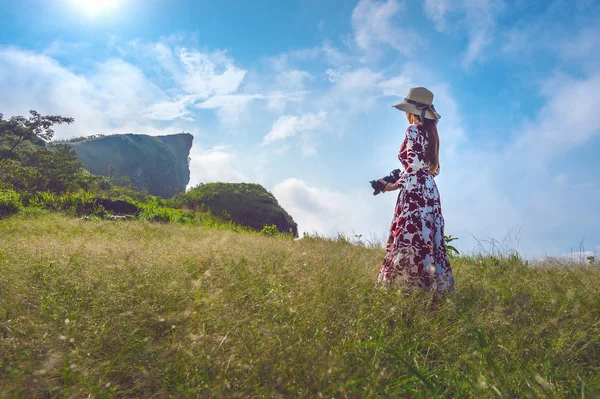 草原の上に立って チェンライ Phu 山中でカメラを保持している女性 旅行の概念 ビンテージ トーン — ストック写真