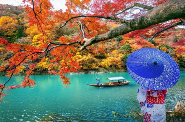 Kyoto nehri boyunca sonbahar sezonunda Arashiyama japon geleneksel kimono giyen Asyalı kadın, Japonya.