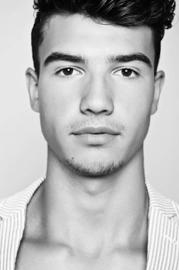 Takım elbise ve şapka ve güneş gözlüğü takan genç adam.