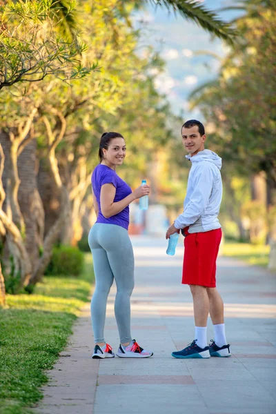 Young Sporty Man Woman Sportswear Drinking Water Jogging — Stock Photo, Image