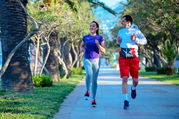 Young Smiling Sporty Man Woman Sportswear Jogging Palm Trees — Stock Photo, Image