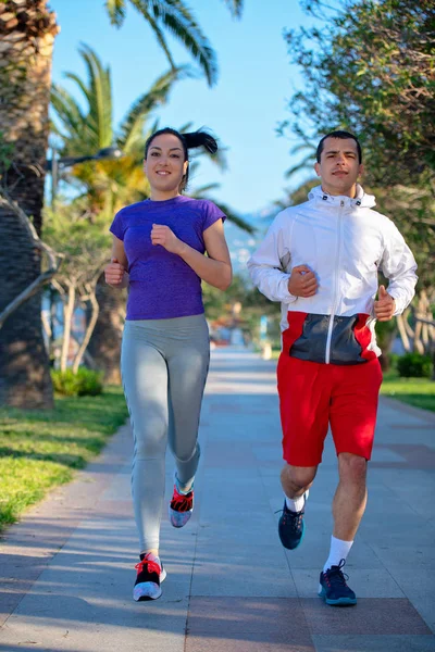 Young Smiling Sporty Man Woman Sportswear Jogging Palm Trees — Stock Photo, Image